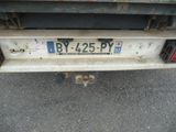 the back end of a truck with a license plate on it