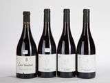 trois bouteilles de vin rouge sont alignées sur une surface blanche