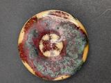 a picture of a picture of a stone with a red and green swirl