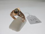 a close up of a ring with a tag on a table
