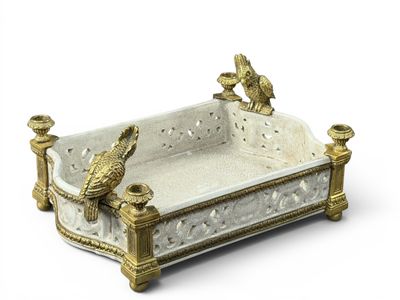 a white and gold tray with two birds on it