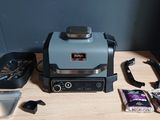 a toaster and a pan on a table next to a microwave