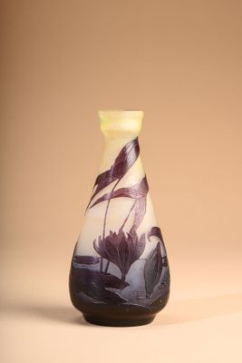 a vase with a bird on it sitting on a table