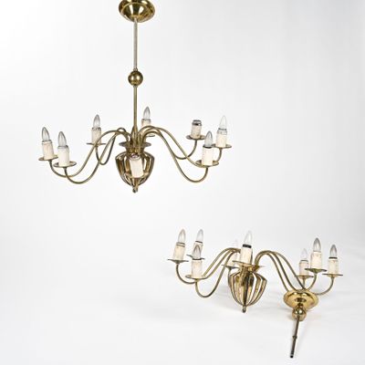 a pair of antique brass chandeliers with glass shades