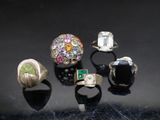 five different colored rings on a black surface
