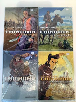 a set of four comic books on a table