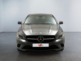 the mercedes cla is parked in a showroom with white walls