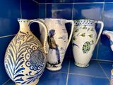 trois vases posés sur un plan de travail carrelé de bleu