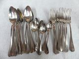 a lot of silver spoons and spoons on the table