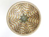 a brown and white bowl on a white table