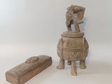 a small wooden box with a statue on it next to a small wooden box