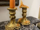 two candles that are sitting on a marble table
