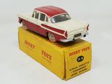 a red and white toy car sitting on top of a yellow box
