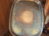 a person holding a metal tray with a brown substance