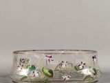 un bol en verre orné de fleurs, posé sur une table