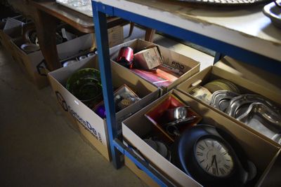 a table with a bunch of boxes and a clock on it