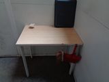 a small table with a suitcase on it next to a wall