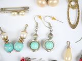 many different types of jewelry on a white surface