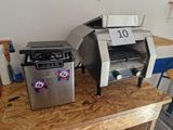 two toasters sitting on a table with a price tag on them