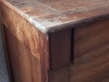 a wooden chest of drawers with a wooden top