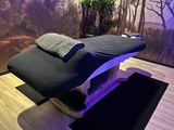 a massage table in a room with a tree in the background