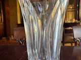 a glass vase sitting on a table in a room