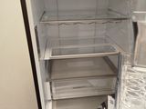 a small refrigerator that is open and has water in it