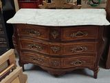 a marble top chest of drawers in a store
