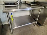 a stainless steel table with a bottle of water on it