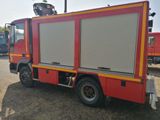 a red and yellow fire truck parked in a parking lot