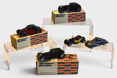 four toy cars on display in a display case