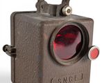 a close up of a small red light on a white background
