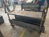 a man working on a metal workbench in a factory