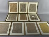 several framed and unframed art pieces of art on a table