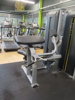 a gym room with treads, machines, and other equipment in it