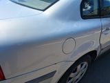 a silver car that is parked in a parking lot