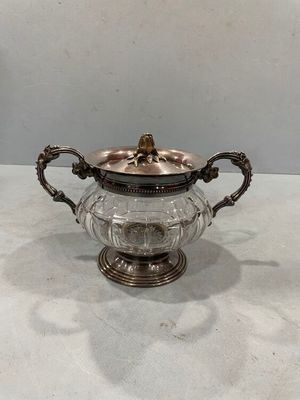 an antique silver plated teapot with a glass lid