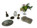 a vase of flowers, a vase of flowers, and other items on a table