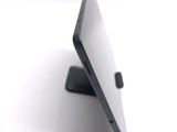 a tablet that is sitting on a stand on a table