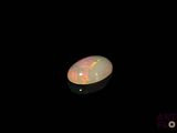 an image of a white fire opal in the dark