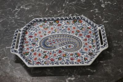 a tray with a paisley design on it on a table