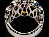 a close up of a ring with many different colored stones