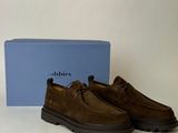 a pair of brown sued shoes sitting on top of a table
