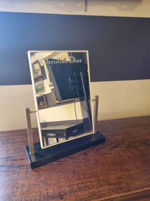 a mirror sitting on top of a wooden table