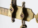 a close up of a metal object with a ruler attached to it