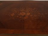 a wooden table with a floral design on it