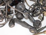 a pile of old telephones and wires on a table