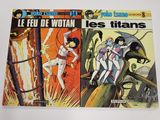 deux bandes dessinées posées sur une surface blanche, dont l'une au premier plan