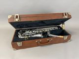 a saxophone in a case with a cigarette in it