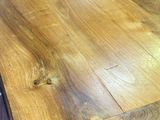 a close up of a wooden table with a metal base